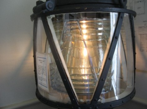 A closeup of a baby Fresnel lens.  Fresnel lenses, which concentrate the output of a small light into one direction, making it look much larger, are some of the most beautiful practical things in existence.