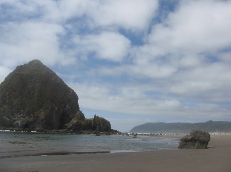 A closer view of Haystack Rock with tidepools at its base.